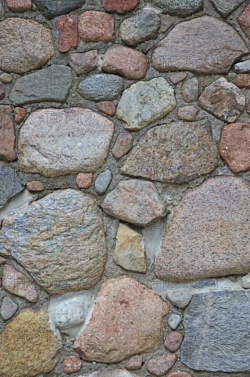 Rustic wall made of natural stones in earthy colors