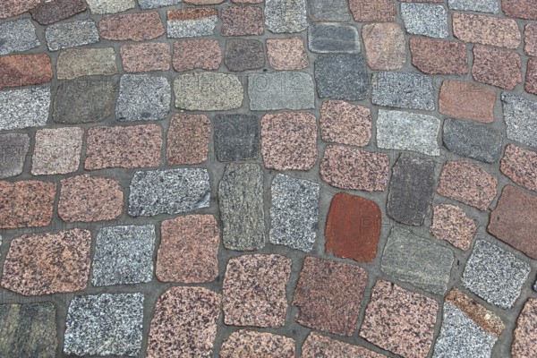 Geometric pattern of dry paving stones in warm colors