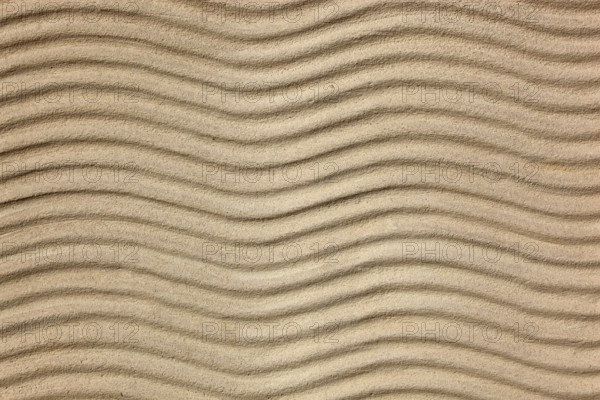 Beige sand with uniform wave patterns