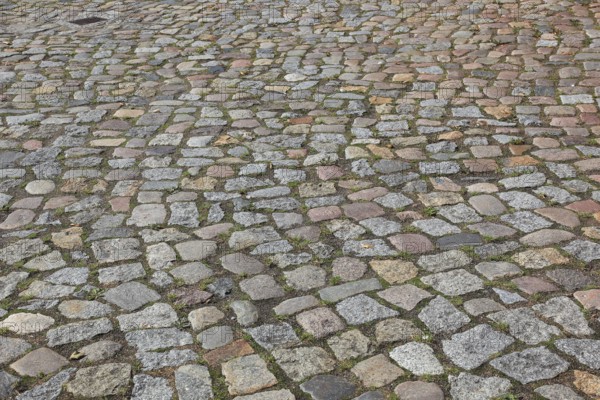 Rough cobblestone road with irregular arrangement of stones