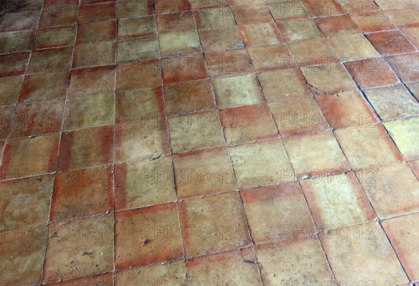 Rustic terracotta tiles with vivid earthy tones and square pattern