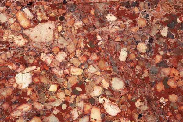 Marble surface in shades of red with diverse patterns and intensive color changes