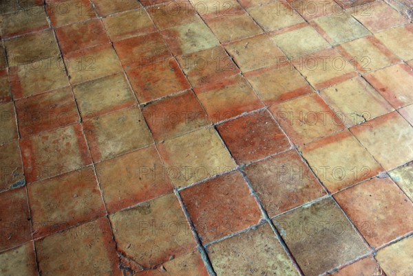Terracotta tiles in warm shades of red with a rustic atmosphere