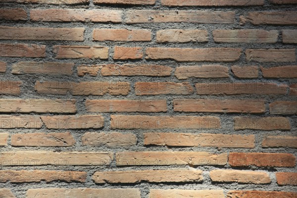 Sun-drenched brick wall with horizontal lines