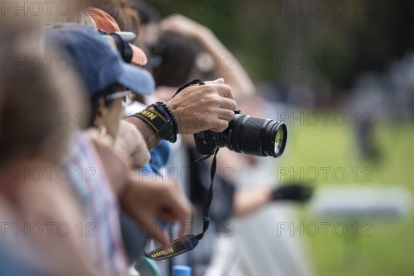 A man's hand holds a Nikon DSLR camera during a sporting event in Buenos Aires, Argentina