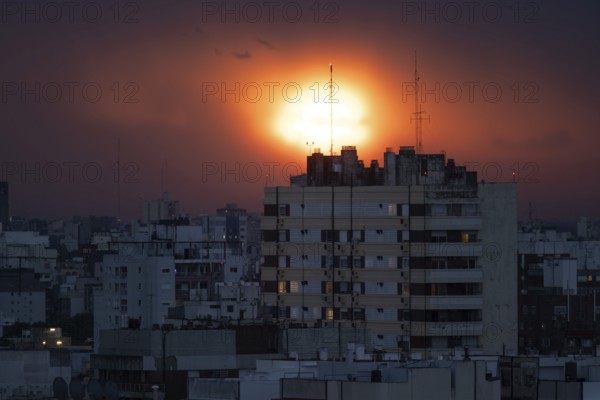 Dramatic sunset over a big city, symbol of climate change and threat to poor countries, Buenos Aires, Argentina