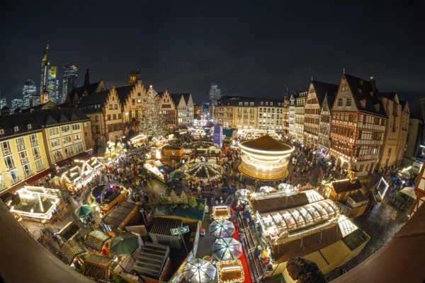 With the lighting on the Mrs. Holle Christmas tree, a 30-meter high Nordmann fir tree, the Frankfurt Christmas Market was officially opened on 24.11.2025. The Christmas market will be open until December 22 from Monday to Saturday from 10:00 to 21:00 and on Sundays from 11:00 to 21:00, Römerberg, Frankfurt am Main, Hesse, Germany