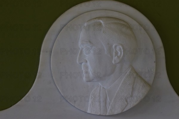 Marble relief depicts Rudolph A. Peterson, a sponsor of the Archaeological Museum in Nemea, marble relief of a man in profile on a green background, artfully and classically designed, Archaeological Museum, Nemea, Peloponnese, Greece