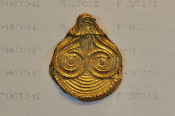 Golden ancient artifact with spiral pattern in teardrop shape, Archaeological Museum, Nemea, Peloponnese, Greece
