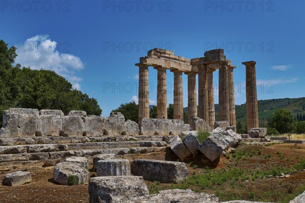 Majestic ancient ruins of a temple with numerous columns and scattered stones, Ancient Sanctuary of Zeus, Archaeological Site, Nemea, Peloponnese, Greece