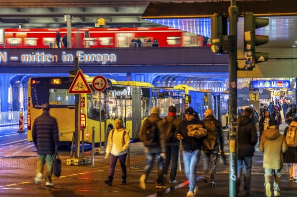 The main train station in Essen, blue illuminated underpass, bus station, am Europaplatz, train on the platform, pedestrian crossing, North Rhine-Westphalia, Germany