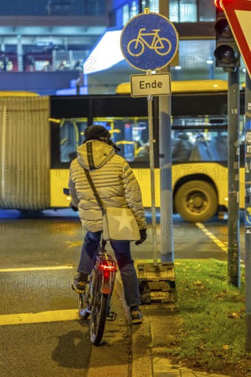 The main train station in Essen, bus station, Europaplatz, pedestrian crossing, traffic light, cyclists waiting at red, North Rhine-Westphalia, Germany