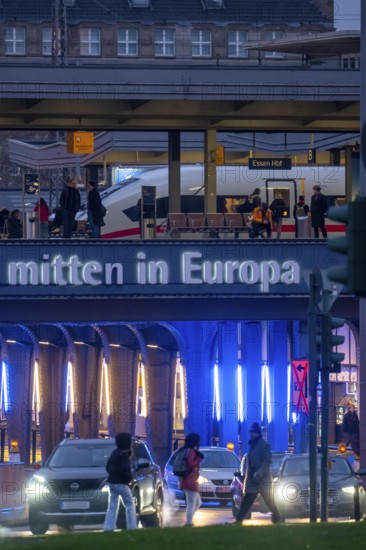 The main train station in Essen, blue illuminated underpass, bus station, am Europaplatz, ICE train on the platform, North Rhine-Westphalia, Germany