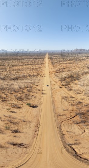 Travel, aerial view, car driving on road through arid landscape, Kunene region, Namibia