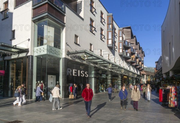 Shoppers walking past Reiss shop store in city centre, Princesshay, Exeter, Devon, England, UK