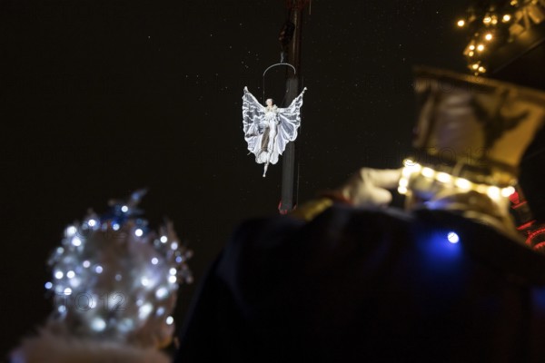 Two Black-winged Stilt walkers watch an artist hovering on a crane at the Christmas market WeihnachtsZauber Gendarmenmarkt on the Gendarmenmarkt, Berlin, 24.11.2025