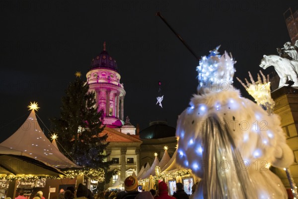 A Black-winged Stilt walker watches an artist hovering on a crane in front of the German Cathedral at the Christmas market WeihnachtsZauber Gendarmenmarkt on the Gendarmenmarkt, Berlin, 24.11.2025