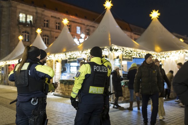 Several policemen guard the Christmas market WeihnachtsZauber Gendarmenmarkt on the Gendarmenmarkt, Berlin, 24.11.2025