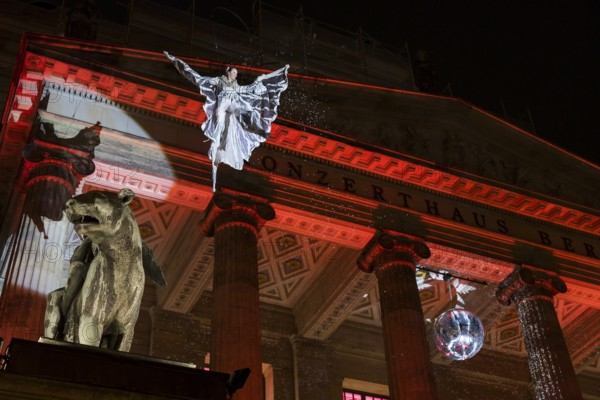 An artist hovers on a crane in front of the concert hall at the Christmas market WeihnachtsZauber Gendarmenmarkt on the Gendarmenmarkt, Berlin, 24.11.2025