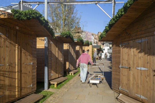Wooden sheds being prepared for Exeter Cathedral Christmas Market, Exeter, Devon, England, UK