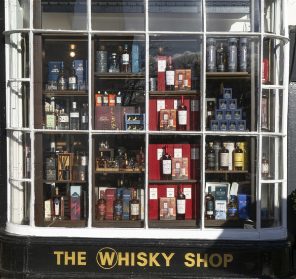 Shopfront window display The Whisky Shop store, Cathedral Close, Exeter city centre, Devon, England, UK