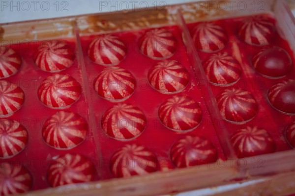 Red chocolate candy with white stripes in a chocolate mold, Christmas baking, Haselstaller Hof, Wildberg, Calw district, Germany