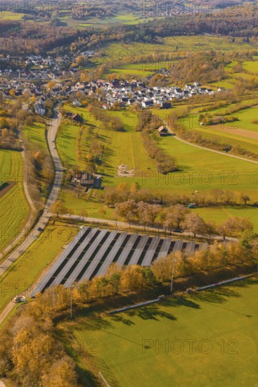 Large-scale solar plant in rural landscape near a village and roads, construction of a PV open-air system, Weil der Stadt, Germany