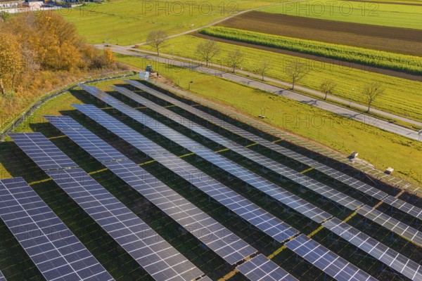 Solar modules in a structured arrangement from an aerial perspective, surrounded by green nature, Bau PV Freifaechenanlage, Weil der Stadt, Germany