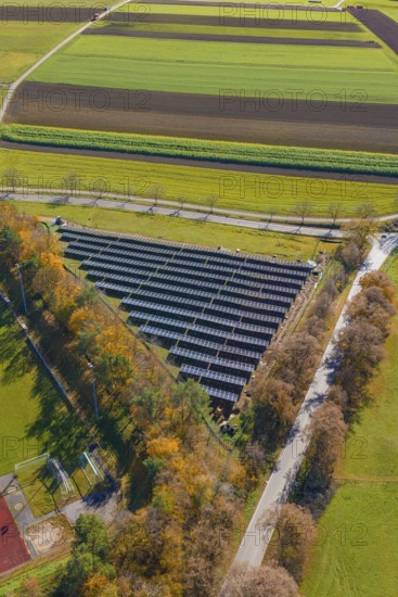 Solar system, nestled in autumnal nature and fields from a bird's eye view, Bau PV Freifaechenanlage, Weil der Stadt, Germany