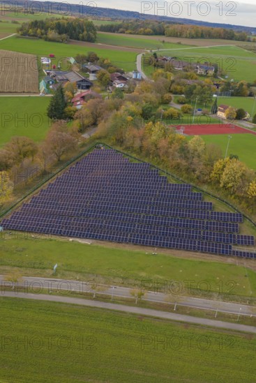Extensive rural views with solar panels next to a small village, construction of a PV open-air system, Weil der Stadt, Germany