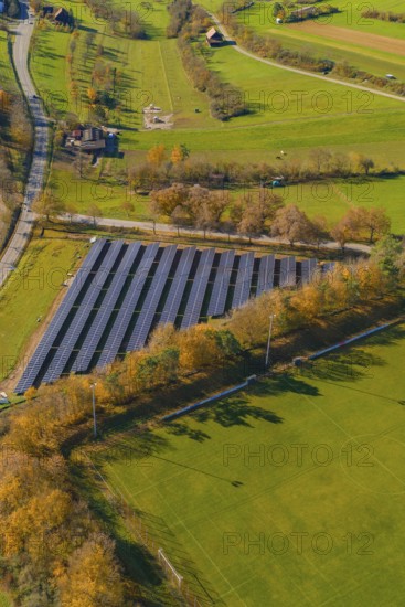 Rural solar farm flanked by trees and connected roads in green surroundings, construction PV open-air plant, Weil der Stadt, Germany