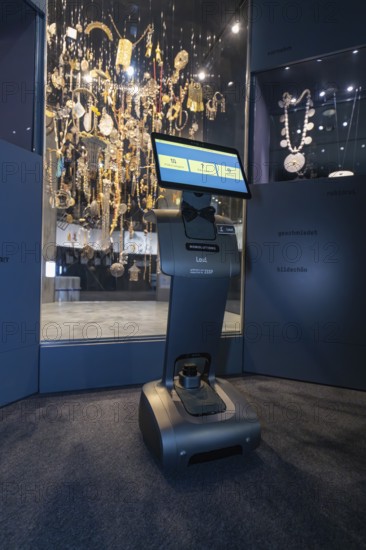 Robot with display stands in front of impressive jewelry exhibition in the museum, robot personality Roboloutions in the jewelry museum, Pforzheim, Germany