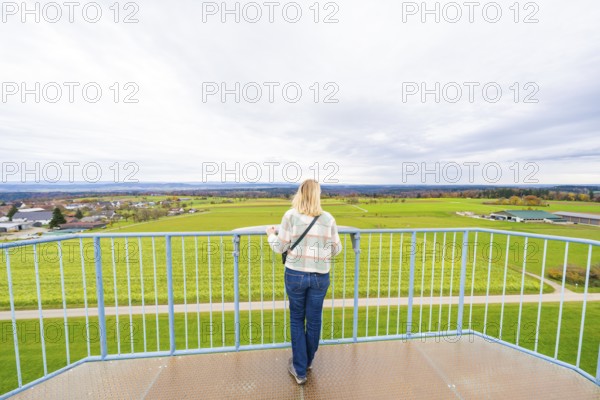 Woman standing on platform looking out over the vast landscape, DÃ¼rrenmettstetten observation tower, Sulz am Neckar, Germany
