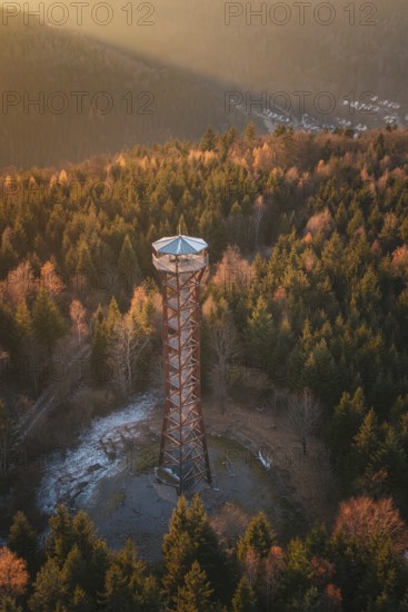 A view of an observation tower surrounded by autumn trees at sunrise, Hohe Warte observation tower, Hohenwart, Pforzheim, Germany