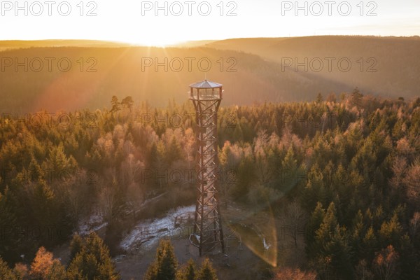 A high observation tower overlooks the autumnal forest at sunrise, Hohe Warte observation tower, Hohenwart, Pforzheim, Germany