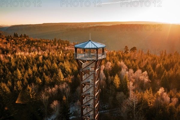 Observation tower stands in front of a wonderful panoramic view of autumnal forest in sunlight, Hohe Warte observation tower, Hohenwart, Pforzheim, Germany