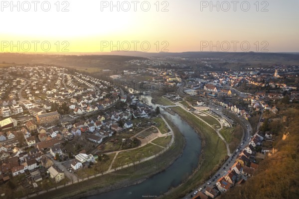 A city on the river appears in the light of the evening sun with diverse architecture, MÃ¼hlacker, Enzkreis, Germany
