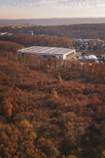 Factory building next to an autumn forest, with urban environment in the background, MÃ¼hlacker, Enzkreis, Germany