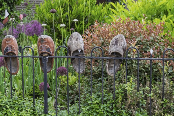 Garden fence with old wooden shoes as decoration, Friesland province, the Netherlands