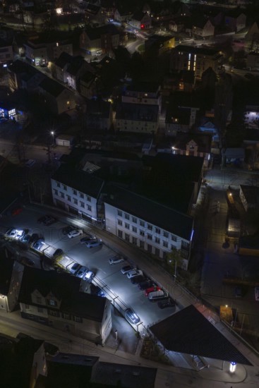 Building with illuminated parking lot in a nocturnal environment, Nagold, Calw district, Germany