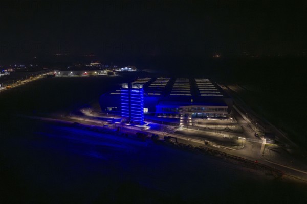 Factory at night with a characteristic blue-lit tower, Nagold, Calw district, Germany