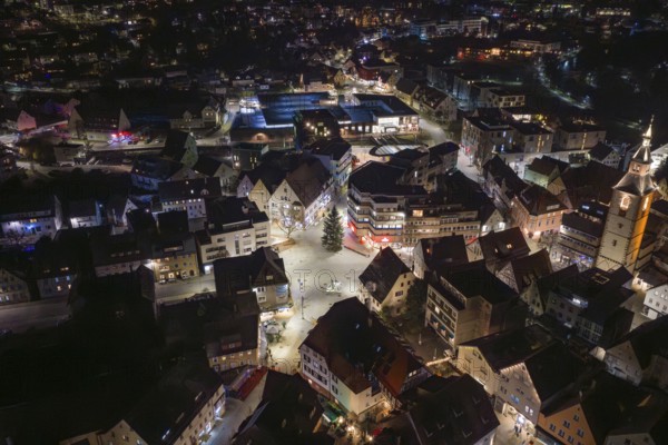 Night view of a city with illuminated streets, many buildings and a church, Nagold, Calw district, Germany
