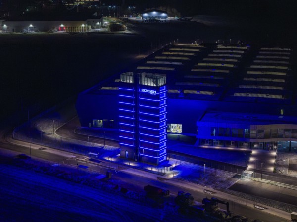 Night view of a factory with a blue illuminated tower and modern buildings, Nagold, Calw district, Germany