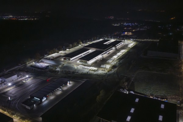 View of industrial area at night with illuminated warehouses and roads, Nagold, Calw district, Germany
