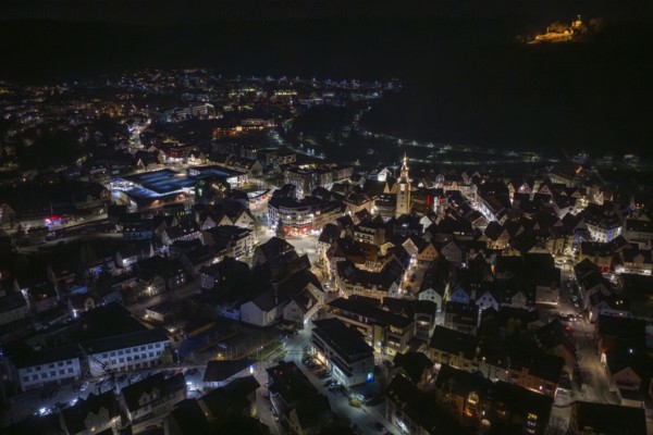 Night view of a city with illuminated buildings and a fortress on a hill, Nagold, Calw district, Germany