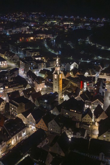 Night view of a city with illuminated buildings and a central church tower, Nagold, Calw district, Germany
