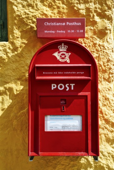 Post office, faÃ§ade detail, red mailbox with post horn and crown, yellow wall, ChristiansÃ¸, Christiansö, Ertholmene, Pea Islands, Bornholm, Baltic Sea, Denmark