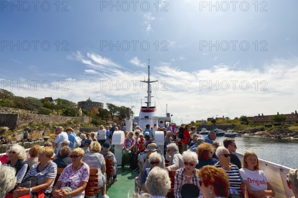 Group of tourists on ferry Ertholm, Danish passenger ship to Gutjem, ChristiansÃ¸, Christiansö, Ertholmene, Pea Islands, Bornholm, Denmark