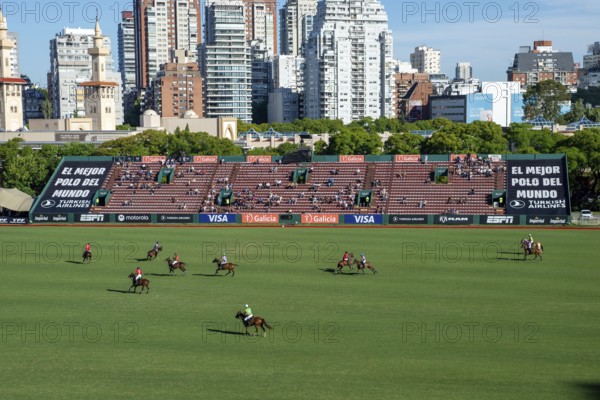 Scene at the 132nd Argentinean Open Polo Championship (Spanish 132nd Abierto Argentino de Polo de Palermo) in the Polo Stadium playing between La Irenita la Hache and La Ensenada with the skyline of Buenos Aires, Argentina