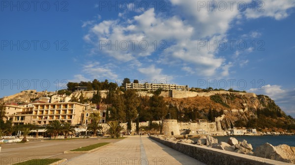 Promenade overlooking the sea and historic buildings under clear skies, Nauplion, Nafplion, Peloponnese, Greece